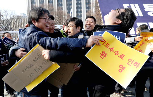 한국중소상인자영업자총연합회 회원들은 이날 서울 종로구 정부서울청사 앞에서 카드수수료 인하 방안을 환영하는 기자회견을 연 뒤 서로 얼싸안으며 기뻐하고 있다. 뉴시스