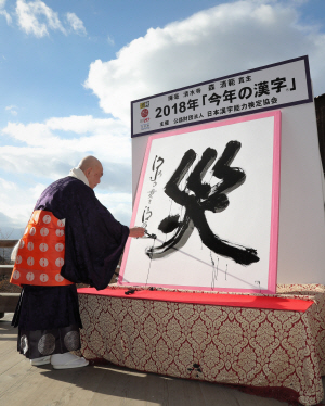 12일 일본 교토의 기요미즈데라(청수사)에서 모리 세이한 주지가 2018년 일본 올해의 한자로 선정된 ‘災(재앙 재)’ 자를 쓰고 있다. EPA 연합뉴스