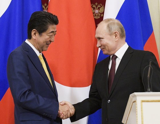 지난 1월 22일 아베 신조 일본 총리와 블라디미르 푸틴 러시아 대통령이 모스크바 크렘믈린궁에서 정상회담을 한 뒤 기자회견에 앞서 악수하고 있다. [AP=연합뉴스]