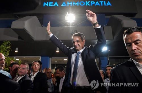 그리스 총선 승리를 사실상 확정지은 뒤 손을 번쩍 치켜 든 키리아코스 미초타키스 신민당 대표 [AFP=연합뉴스]
