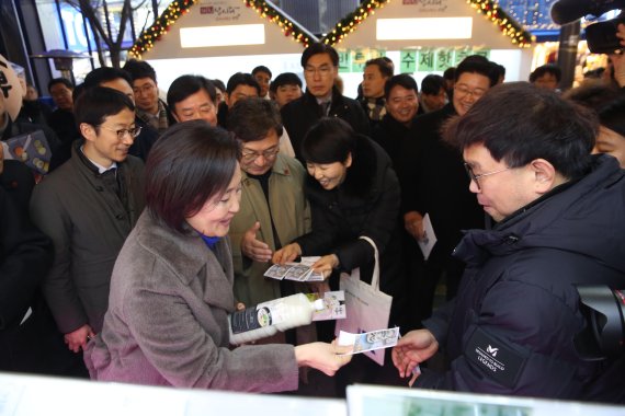 박영선 중소벤처기업부 장관(앞줄 왼쪽 첫번째)이 지난 28일 서울 신촌 연세로에서 열린 2020년 가치삽시다 행사에 방문해 소상공인 제품을 구매하고 있다. 중기부 제공