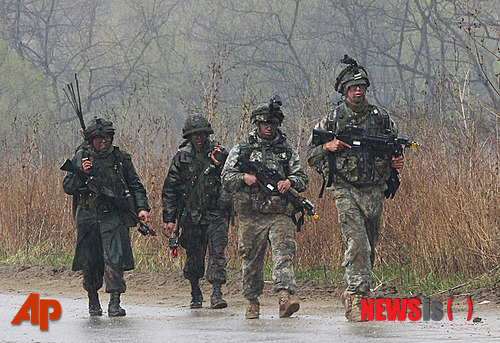 [파주=AP/뉴시스]한미 육군 장병들이 비가 오는 가운데 철책선 인근에서 걸어가고 있다. 2013.40.25.