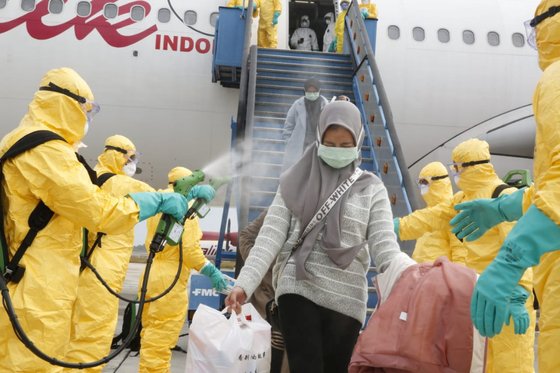 중국 우한에서 귀국한 인도네시아 교민들이 소독을 받고 있다. [로이터=연합뉴스]