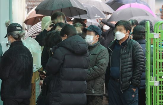 비가 내리는 28일 충북 청주시 오송읍에 있는 한 우체국에 오후 2시부터 판매하는 마스크를 구매하기 위해 시민들이 모이고 있다. 연합