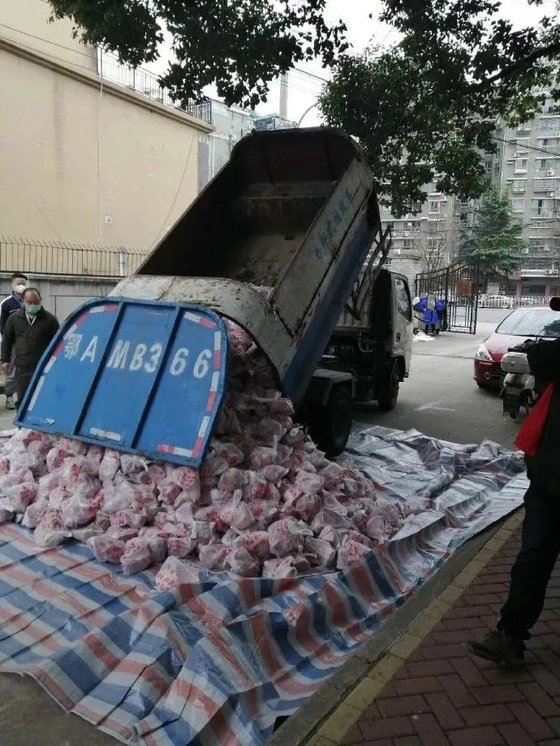 지난 11일 중국 우한 시민에 배달된 돼지고기가 쓰레기차에서 쏟아지고 있다. [중국 환구망 캡처]