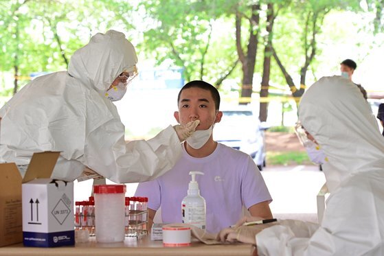 18일 육군훈련소로 입소한 입영 장정이 PCR검사 전수조사를 위한 검체 채취를 하고 있다.연합뉴스