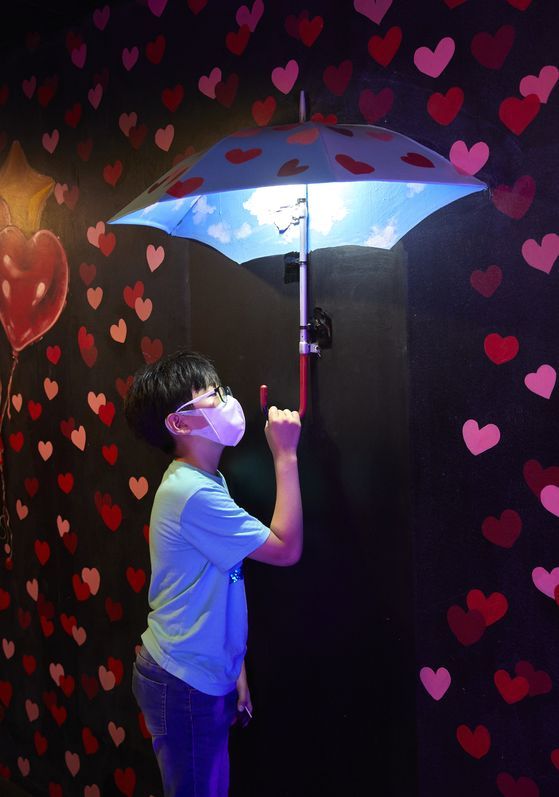 안강 학생기자가 '박물관이 살아있다'에 전시된 착시 우산을 잡아보며 신기해하고 있다.