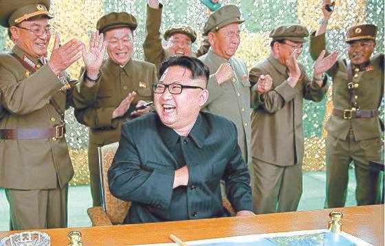 북한 김정은 노동당 위원장(가운데)이 2016년 6월 화성-10(무수단 미사일)' 시험 발사에 성공한 뒤 환하게 웃고 있다. 맨 왼쪽에서 박수를 치고 있는 사람은 김락겸 전 전략군 사령관. [중앙포토]