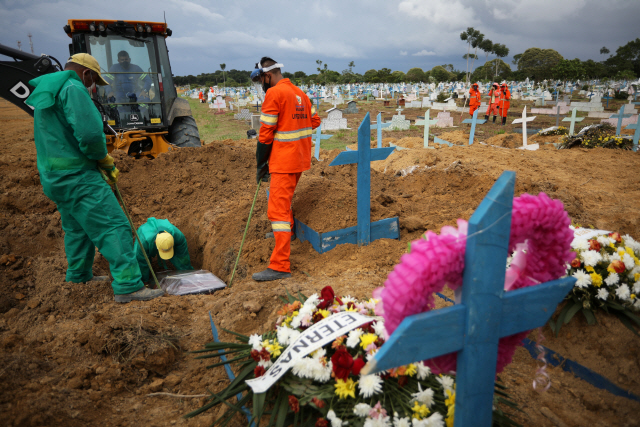 8일(현지 시간) 브라질 마나우스에서 공동묘지 인부들이 코로나19 사망자를 매장하고 있다. /로이터연합뉴스