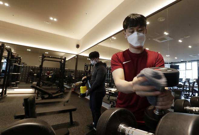 헬스장 등 실내체육시설 영업 재개를 하루 앞둔 17일 오후 서울 구로구 어반필드 신도림점에서 직원이 매장 내 방역 소독 및 청소를 하고 있다. 김혜윤 기자 unique@hani.co.kr