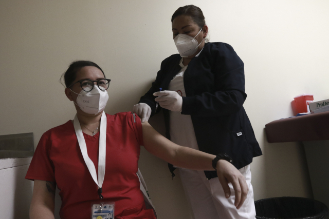 멕시코 국경도시 시우다드후아레스에서 신종 코로나바이러스 감염증(코로나19) 백신 접종 첫날인 13일(현지시간) 한 간호사가 화이자 백신을 접종받고 있다. /연합뉴스