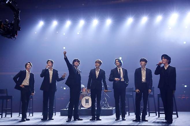 BTS presented its hit song Dynamite on the online Charity Performance Music On a Mission by Charity group MusicCares at the United States of America Recording Academy on Wednesday.The venue was set in the empty Venues, which seemed to have produced a situation where the popular music concert was lost in the face of the fandemic.Members who appeared one by one at the Venues entrance and the audience gathered on the main stage to present Dynamite live.He sat in a chair in a suit, not a dance, and shook himself lightly, creating an atmosphere. Jungkook also played drums.Music on a Mission has been held as a gala show with the selection of Person of the Year every year, but this year it was conducted in the form of an online concert due to Corona 19.Ticket sales are used to help people in the music industry who have been hit by Corona19, including BTS, John Legend, Zne Aiko, Haim and He (H.E.R.)BTS performance is also attracting attention to the 63rd Grammy Awards, which has been around for two days.BTS, nominated for Best Pop Iruvar/Group Performance, will be the first Korean singer to perform solo at the awards ceremony.The stage was reportedly filmed in Korea in advance.Jack Susman, vice president of United States of America CBS, who broadcasts the awards ceremony, raised expectations earlier, foreshadowing the United States of America media variety, saying,  (seeing BTS performance) you will not be sitting still in the living room.The awards ceremony will be held at 9 am on the 15th in Korea and the Best Pop Iruvar/Group Performance awards will be announced at the Grammy Awards Premiere Ceremony held at 4 am.