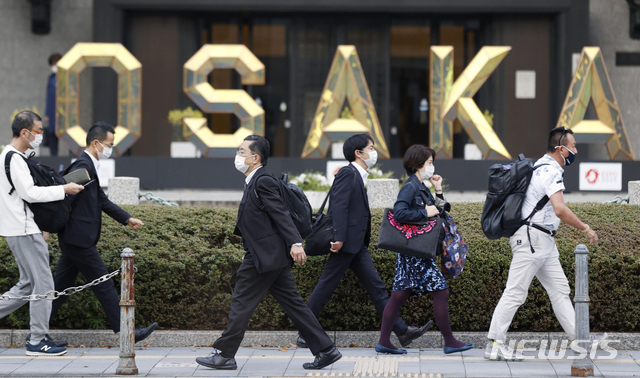 [오사카=AP/뉴시스]지난 5일 일본 오사카에서 코로나19 확산을 막기 위해 마스크를 쓴 사람들이 길을 걸어가고 있다. 2021.04.07.