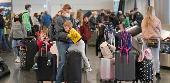 지난 3월17일 미 솔트레이크시티 국제공항에서 여행객들이 짐을 옮기고 있다. 국제 통계사이트 아워월드인데이터에 따르면 21일 기준 미국인 40.2%가 1회 이상 접종, 완전 접종자 비율은 26.2%를 기록했다.[AP=뉴시스]