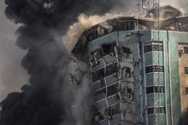 15일(현지시간) 외신들이 다수 입주한 팔레스타인 가자지구 내 '잘라 타워'가 이스라엘의 공습을 받고 연기를 내뿜으며 무너져 내리고 있다. 잘라 타워는 12층 규모로, 이스라엘측은 공습 1시간 전에 입주사들에 대피할 것을 사전 경고했다. [연합]