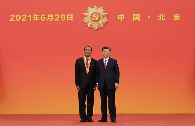 시진핑(오른쪽) 중국 국가주석이 지난 29일 베이징(北京) 인민대회당에서 당과 인민에 큰 공헌을 한 당원에게 ‘7·1 훈장’을 수여한 뒤 기념 촬영을 하고 있다. [EPA]