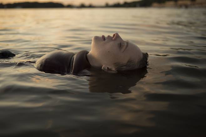 '그리고 베를린에서'의 한 장면. 무거운 가발을 벗어던지고 호수에 몸을 맡긴 주인공 에스티의 모습./넷플릭스