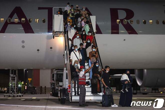 아프가니스탄 난민들이 10일(현지시간) 카타르 수도 도하 소재 하마드 국제공항에 도착했다. 2021.09.10 © AFP=뉴스1