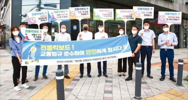 개인형 이동장치 연구모임을 구성한 천안시의회 의원들이 현수막과 피켓을 들고 거리캠페인을 펼치고 있다. /천안시의회 제공