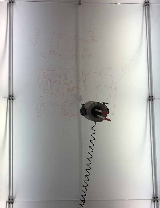 Scribit is shown here drawing a map at the biennale. [SHIN MIN-HEE]