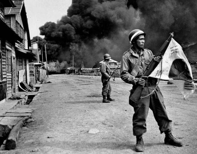 1948년 10월 여순사건을 진압한 뒤 여수 시가지에 진출한 국군. 짙은 연기를 뒤로 한 채 군인들이 긴장한 얼굴로 주위를 살피고 있다./게티이미지코리아