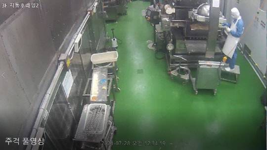 던킨 안양공장 CCTV의 한 장면. SPC 측은 영상 속 직원이 주걱으로 유증기를 반죽 위에 털고 있는 모습이라고 설명했다. <SPC그룹 제공>