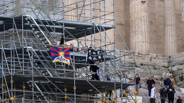사진= 시위대가 10월 17일 그리스 아테네의 아크로폴리스 언덕 비계에서 티베트 국기와 현수막을 들고 있다, AP연합뉴스