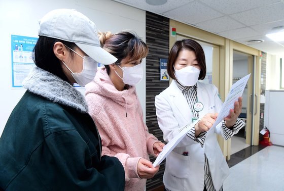 18일 서울 양천구 홍익병원에서 한 학생이 코로나19 백신접종을 마친 뒤 어머니와 함께 관계자에게 주의사항을 듣고 있다. 연합뉴스