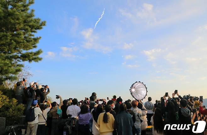 21일 오후 전남 고흥군 우주발사전망대를 찾은 시민들이 누리호 발사가 시작되자 휴대전화기로 사진과 영상을 찍고 있다. 2021.10.21/뉴스1 © News1 이수민 기자
