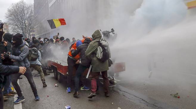 5일 벨기에 브뤼셀에서 코로나 규제에 반대하는 시위가 벌어지자 경찰이 물대포와 최루탄을 쏴 해산시키고 있다. EPA=연합뉴스