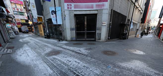 북적이던 명동이 언제였던가… 정부는 최근 코로나19 유행 규모가 감소하는 등 방역 지표가 호전됐지만, 오미크론 변이 확산이라는 변수가 있는 만큼 현행 거리 두기 조정 여부를 신중히 검토해 14일 발표하기로 했다. 사진은 11일 오후 인적이 끊겨 한산한 서울 명동의 거리. 연합뉴스