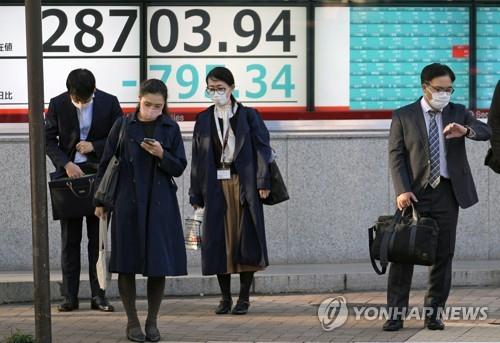 일본 증시 시황판 앞에 서 있는 보행자들 [EPA=연합뉴스 자료사진]