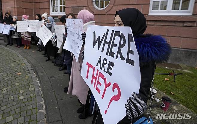 [AP/뉴시스] 13일 독일 코블렌츠 법원 앞에서 시리아 난민 여성들이 시리아 아사드 정권을 규탄하는 종이를 들고 서있다