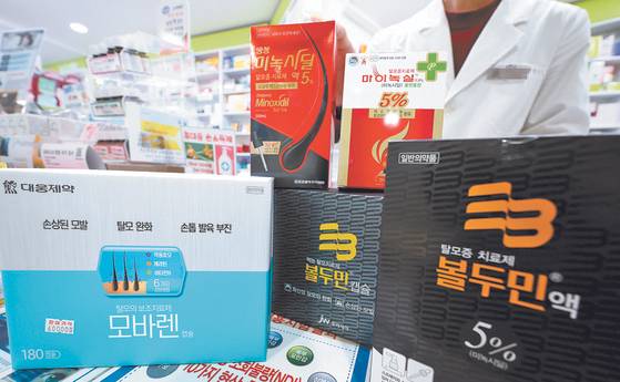Hair loss treatment medications in a drug store in Seoul. [YONHAP]