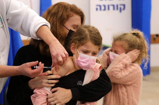 지난 2일(현지시간) 이스라엘 중부 모디인에서 '클라리트 건강 서비스'(CHS) 의료진이 한 어린이에게 화이자-바이오엔테크의 코로나19 백신을 접종하고 있다. AFP연합