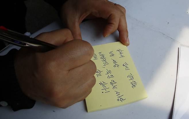 구의역 참사 6주기 추모 기자회견에 참석한 노동자가 추모 글을 쓰고 있다. 김혜윤 기자 unique@hani.co.kr