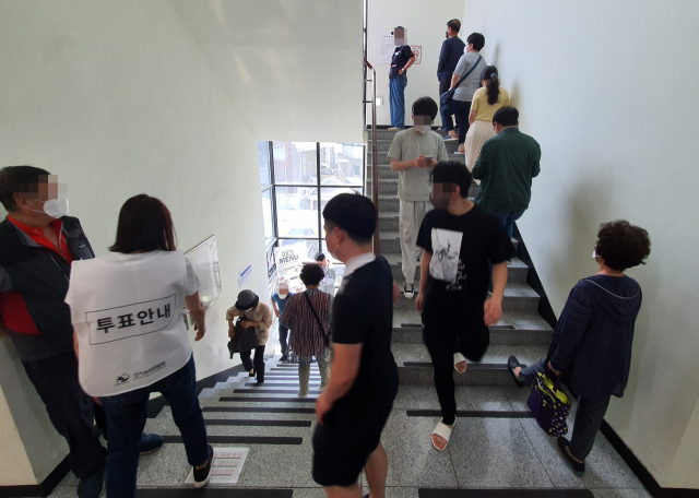 28일 중랑구 묵1동 사전투표소 계단에서 시민들이 순서를 기다리고 있다. 연합뉴스