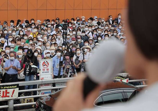 내달 10일 실시되는 일본 참의원 선거 유세 첫날인 22일 도쿄에서 유권자들이 선거 유세 연설을 듣고 있다.    도쿄 AFP=연합뉴스
