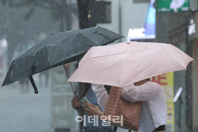 장마가 시작되며 전국적으로 많은 비가 내리고 있는 26일 오후 서울 중구 명동 일대에서 시민들이 우산을 쓴 채 이동하고 있다.(사진=이영훈 기자)