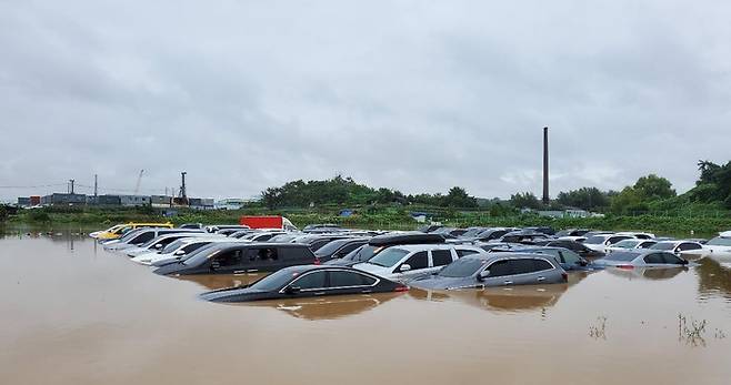 30일 오전 경기 남부 지역에 시간당 최대 50㎜ 넘는 폭우가 쏟아지면서 도로 침수와 가로수 전도 등의 피해가 잇따랐다. 사진은 침수 피해 입은 수원 중고차단지 모습. 연합뉴스