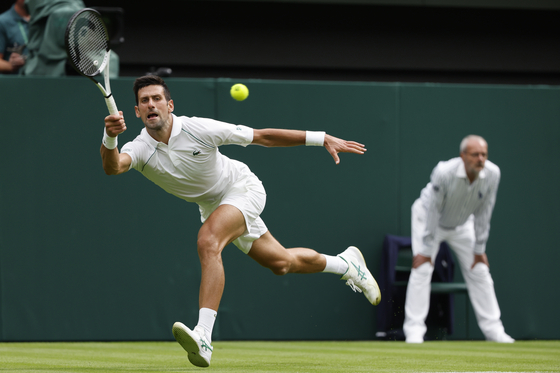 Novak Djokovic of Serbia in action against Kwon Soon-woo during the men's first round singles match on day one of the Wimbledon tennis championships at the Centre Court of the All England Lawn Tennis and Croquet Club in London on Monday. [EPA/YONHAP]