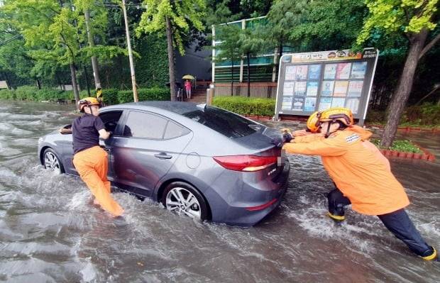 인천지역에 폭우가 내린 8일 인천시 미추홀구 용현동 한 도로에서 소방대원들이 침수된 차량을 안전한 곳으로 옮기고 있다. /사진=연합뉴스