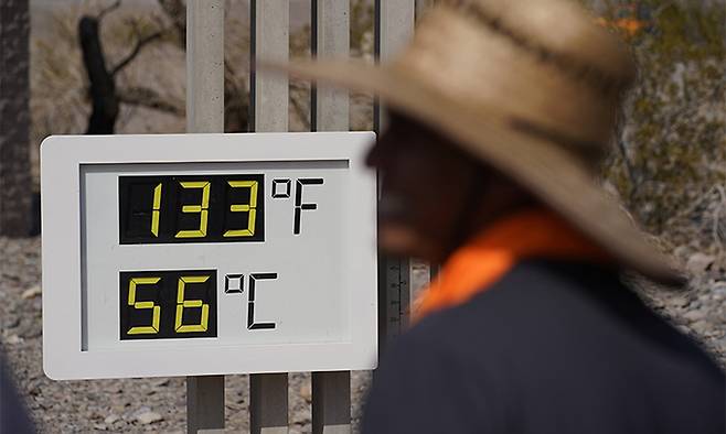 2021년 7월 11일(현지시간) 미국 캘리포니아주 데스밸리 국립공원에서 한 남성이 화씨 133도(섭씨 56도)를 가리키는 온도계를 바라보고 있다. 데스밸리=AP연합뉴스