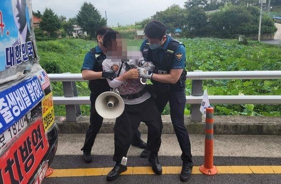 16일 오전 문재인 전 대통령 사저가 있는 양산 하북면 평산마을 앞 도로에서 흉기를 휘두른 60대 남성이 경찰에 체포되고 있다. /뉴스1