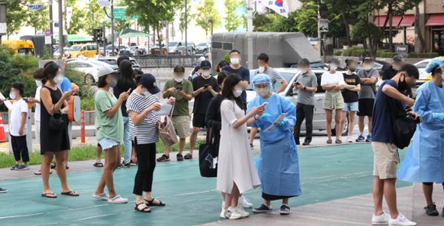 코로나19 일일 확진자 수가 8만4,128명을 기록한 16일 오전 서울 송파구 선별진료소에서 시민들이 검사를 받기 위해 길게 줄 서 있다. 뉴시스