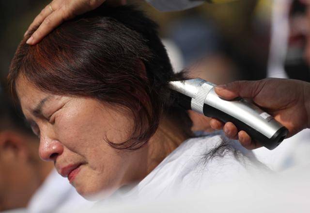 '세계 자폐인의 날'인 2018년 4월 2일 서울 종로구 청운효자동 주민센터 앞에서 전국장애인부모연대 등이 발달장애인 국가책임제 도입을 촉구하며 삭발식을 하고 있다. 뉴시스 자료사진