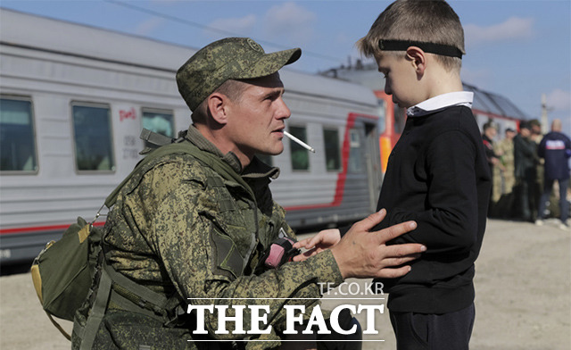 러시아에 '부분 동원령'이 발표된 가운데 29일(현지시간) 러시아 볼고그라드주 프루드보이 기차역에서 군에 징집된 젊은 남성이 기차에 오르기 전 아들과 대화를 나누고 있다. /프루드보이=AP.뉴시스