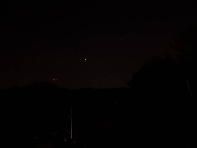 Mars is observed as a small orange dot on the night of Nov. 16. (Lee Si-jin/The Korea Herald)
