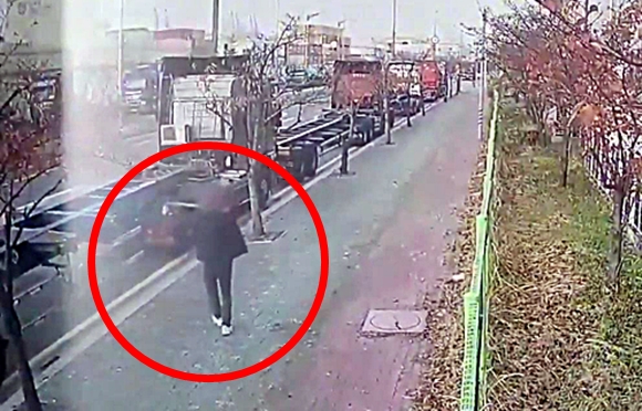 지난달 26일 화물연대 조합원 중 한 명이 부산 강서구 부산신항 인근에서 도로를 향해 쇠구슬을 쏘는 모습. 부산경찰청 제공