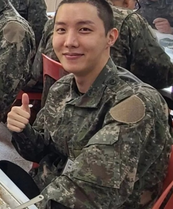 A number of photos of J-Hope in military life were posted on the online community on Tuesday.J-Hope showed a distinctive bright smile even after receiving tough military training, such as the 20km night march, which is the hardest training of the new shift training.He boasted an Energizer-like presence among his motives, while carrying military uniforms, helmets, 5kg rifles, and about 20kg heavy armor.A photo of J-Hope, who took off his military cap, was also released. J-Hope showed a lively military life by posing in a V-shaped pose with a short short haircut.He also announced that he was continuing his military life with a smile on his previous training photos.J-Hope was the second of seven members of the BTS to enlist, after Jin.